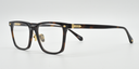 brown rectangular frame. side view showing small gold detail to the front and arm close to the hinges