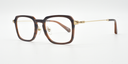 Rectangular tortoiseshell frame glasses. side view. Gold coloured hinge highlights and gold coloured arms