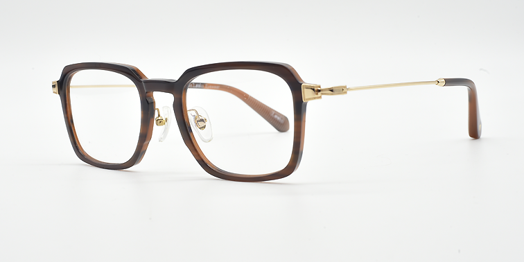 Rectangular tortoiseshell frame glasses. side view. Gold coloured hinge highlights and gold coloured arms