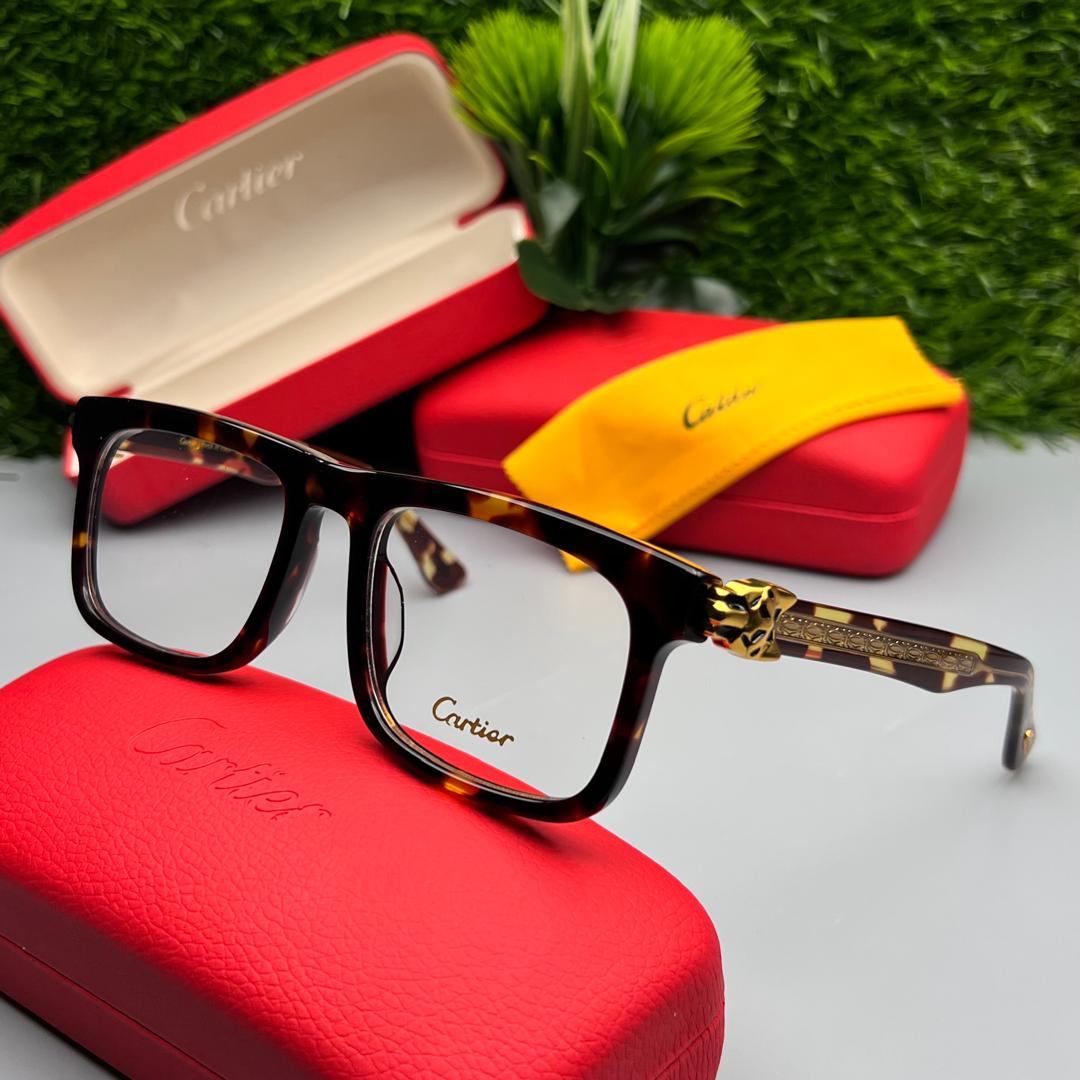 Cartier eyeglasses with red case on a gray surface