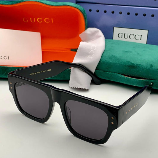 Black Gucci sunglasses with packaging in the background