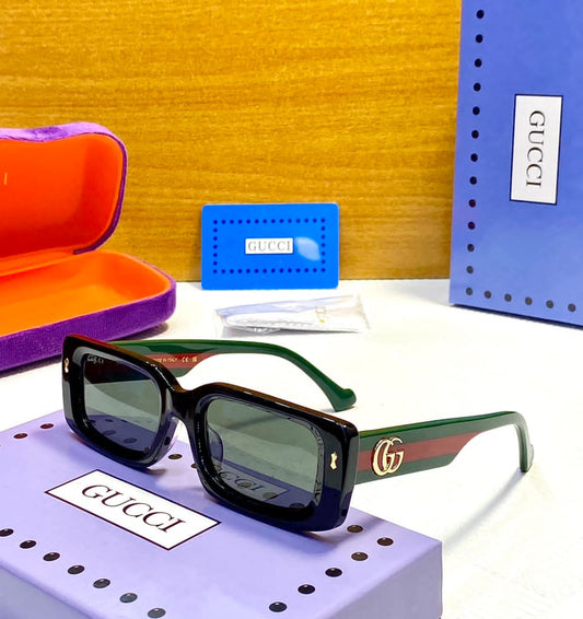 Gucci sunglasses with packaging on a yellow background
