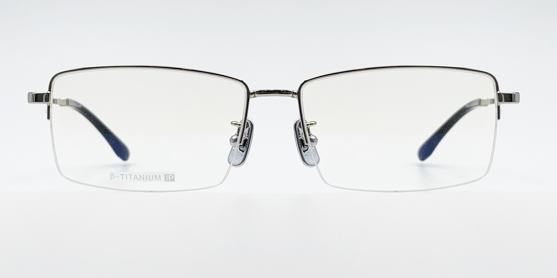 silver coloured rectangular titanium half frame. Front view showing silver coloured bridge 