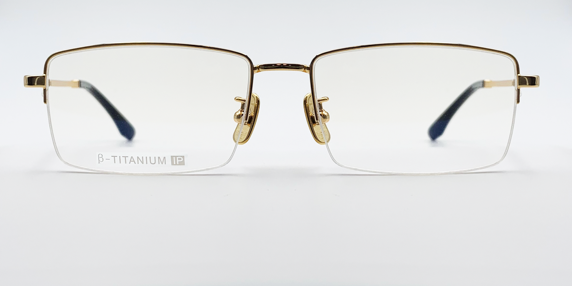 gold coloured rectangular titanium half frame. Front view showing gold coloured bridge 