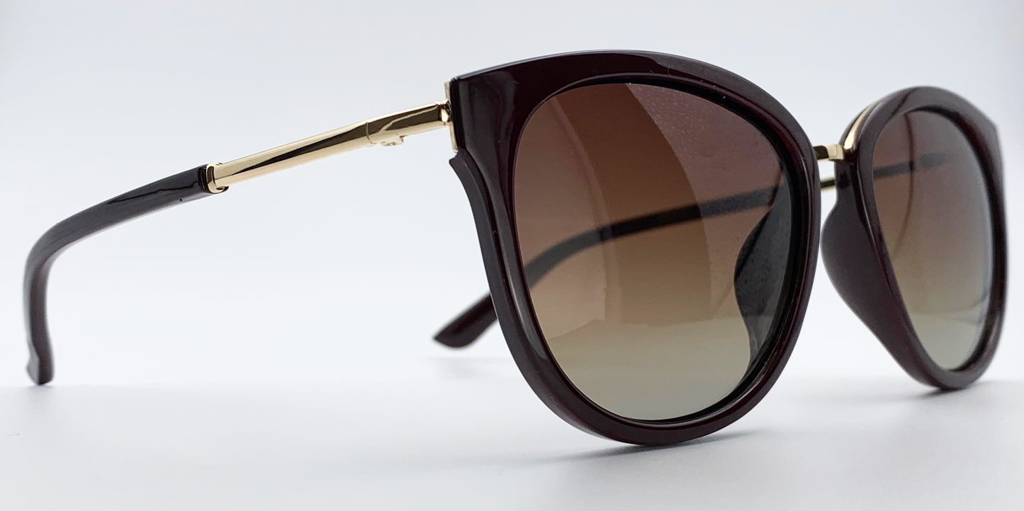 side view. Stylish semi-cat eye glasses  in dark brown with tinted glasses. gold coloured features
