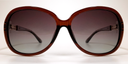 Front view, large rounded rectangular black frame with tinted lenses