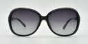 Front view, large rounded rectangular black frame with tinted lenses