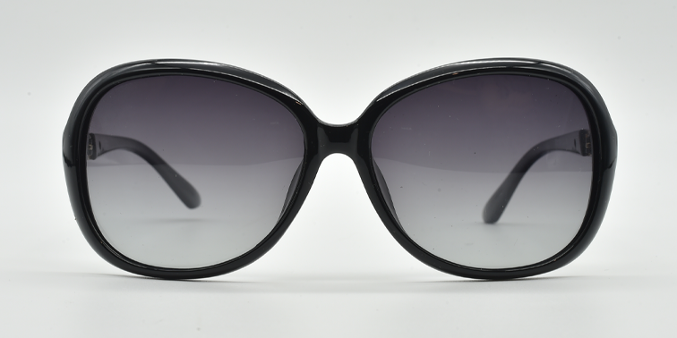 Front view, large rounded rectangular black frame with tinted lenses