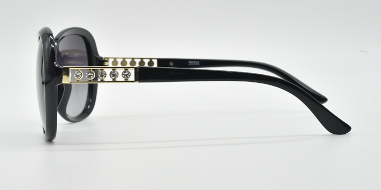 side view, large rounded rectangular black frame with tinted lenses. gold with 5 small gemstones detail on top part of the arm.