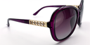 side view, large rounded rectangular purple frame with tinted lenses. gold with 5 small gemstones detail on top part of the arm.