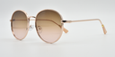 Side view, round frame with tinted lenses. gold embellishments around the frame.