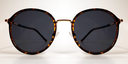 front view of round retro-style tortoiseshell  frame with gold coloured bridge and gold embellishments 