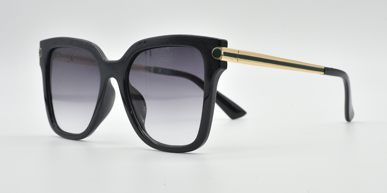 side view black rounded rectangular frame with small circular detail on front extending down the arms. Tinted lenses.
