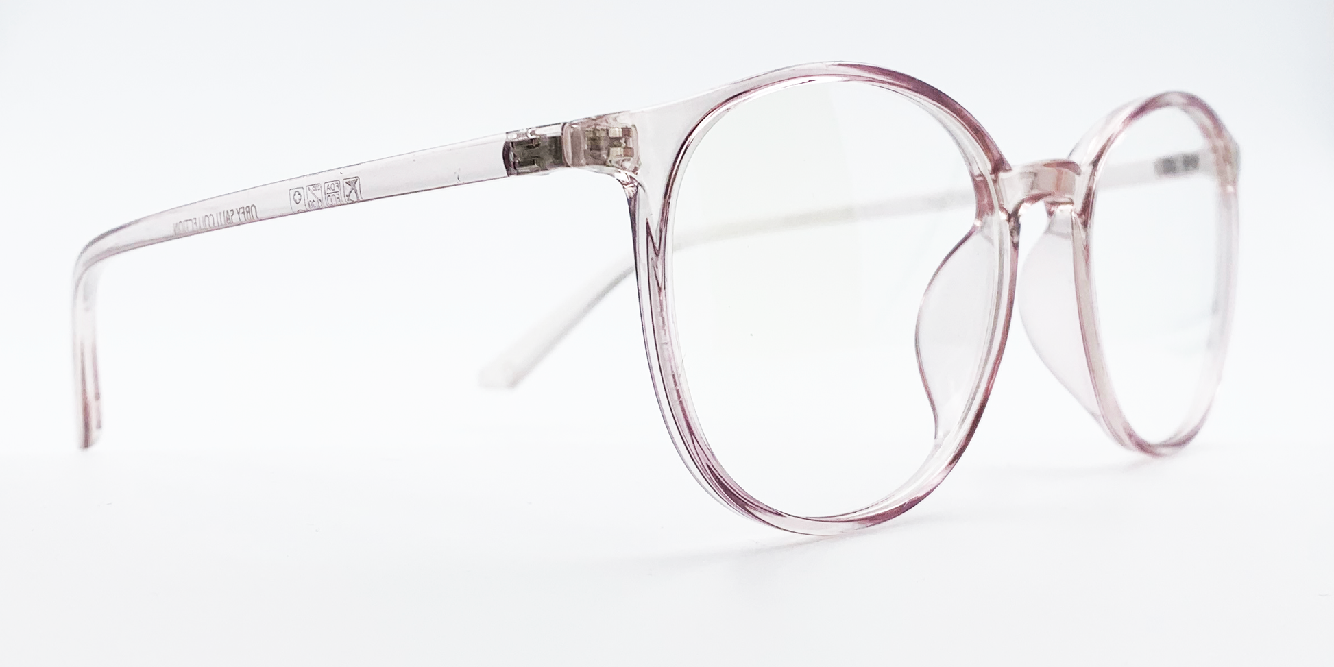 Side view of clear round retro-style glasses. frame and arms same colour.