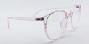 Side view of clear with a hint of pink round retro-style glasses. frame and arms same colour.