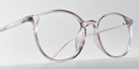 Side view of clear round retro-style glasses. frame and arms same colour.