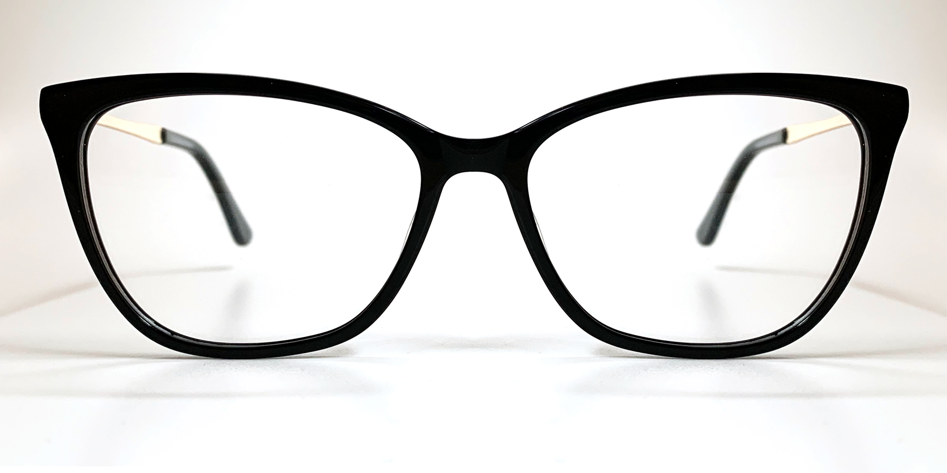 Front view. Black cat's-eye frame glasses. Gold coloured  inner, black coloured outer arms.