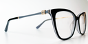 side view. showing square crystal feature, with gold coloured surround, close to the hinge area . Black front cat's-eye frame glasses with black, white and grey surround. Gold coloured inner and Grey coloured outer arms.
