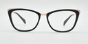 Front view. black cat's-eye frame showing gold coloured highlights to the top corners of the frame. 