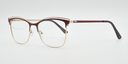 side view of red frame. Fine metal above creating eyebrow detail on top of the frame. Half rimless frame. red arms.