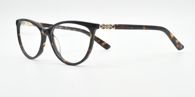 Front/side view. Cat's eye glasses in tortoiseshell colour. Gold flower detail at top of the arm