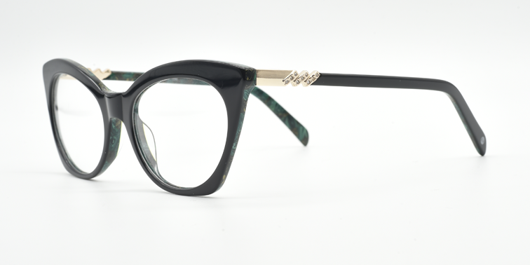 Front/side facing green cat's eye frame showing zig-zag crystal detail on the arm