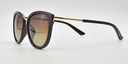 side view. Stylish semi-cat eye glasses  in dark brown with tinted glasses. gold coloured features