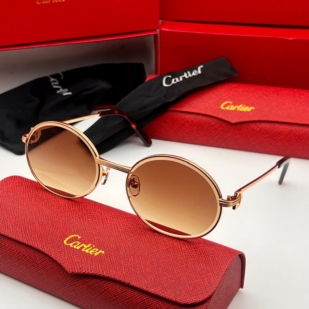 Cartier sunglasses with red case and box on a white background