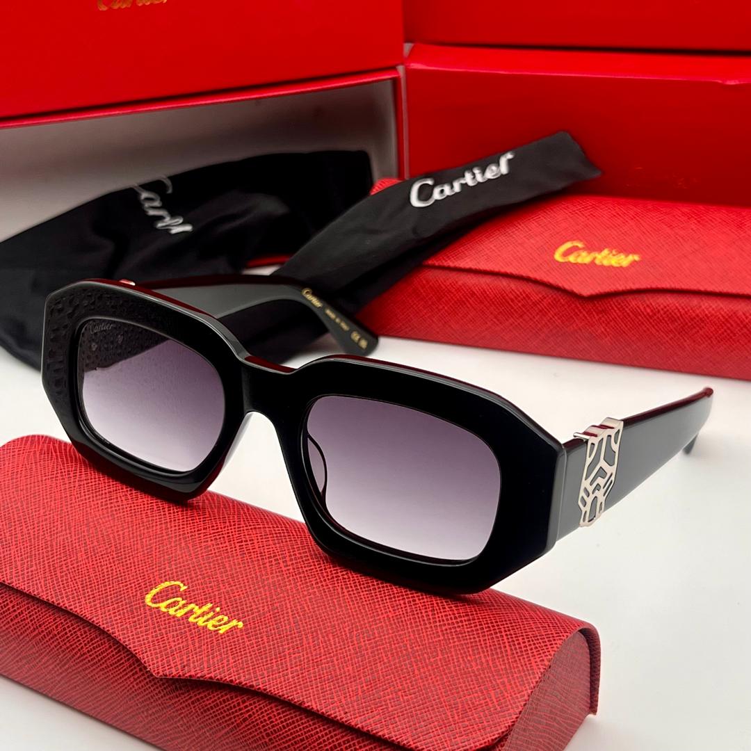 Black Cartier sunglasses on a red case with a red box in the background