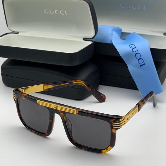 Gucci sunglasses with case and cloth on a white background