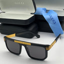 Black and gold Gucci sunglasses with case and cloth on a white background