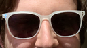 photo of model wearing white frame with tinted lenses