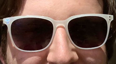 photo of model wearing white frame with tinted lenses