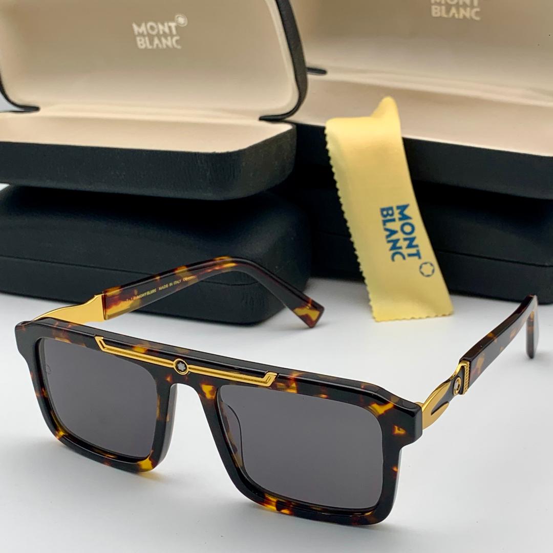 Mont Blanc sunglasses with tortoiseshell frame and gold accents on a white surface.