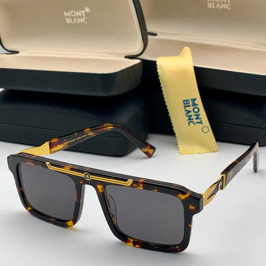 Mont Blanc sunglasses with tortoiseshell frame and gold accents on a white surface.