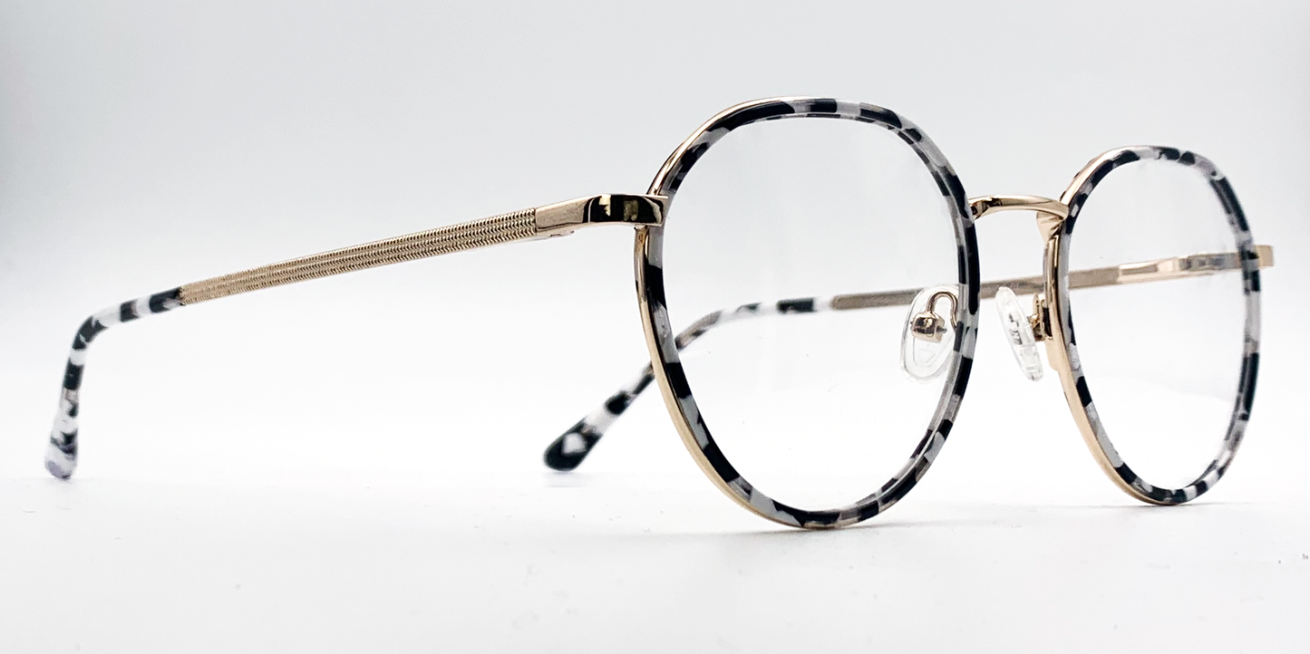 black and white round retro-style frame. Side view showing gold coloured bridge and arm