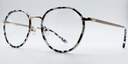 black and white round retro-style frame. Side view showing gold coloured bridge and arm