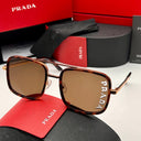 Prada sunglasses with red case and packaging on a white background